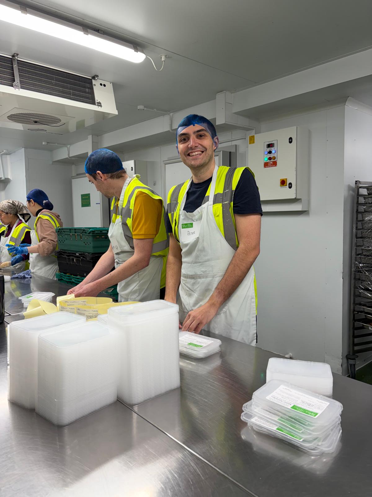 Packing food containers at the Felix Project kitchen